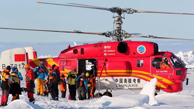 Researchers and passenegers leave the Chinese rescue helicopter after being evacuated from the ship Akademik Shokalskiy in Antarctica.