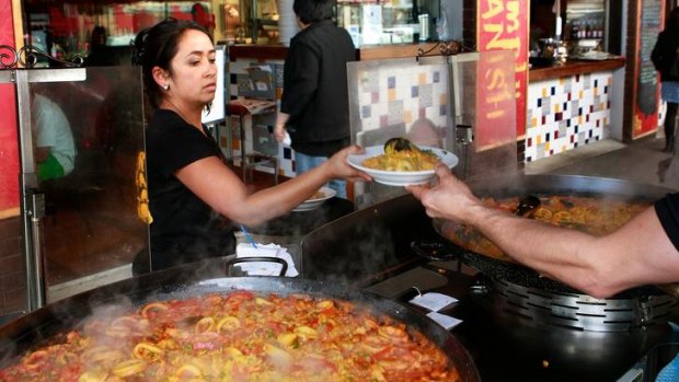 Under a bank of footpath umbrellas, next to the paella cart with giant trays of sizzling seafood and chicken, you kind of feel like you're on holiday in your own city.