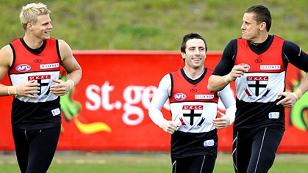 St Kilda captain Nick Riewoldt, who continues to train well, runs with Stephen Milne and Michael Gardiner yesterday.