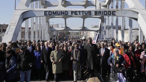 Vice President Joe Biden and U.S. Rep. John Lewis, D-Ga., lead a group across the Edmund Pettus Bridge in Selma, Ala., Sunday, March 3, 2013.