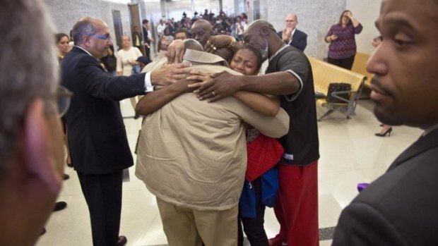Powerful: David McCallum, centre, is embraced by his immediate family after his exoneration on Wednesday.