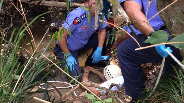 Paramedics and firefighters work to free an elderly man who was trapped in Mountain Creek after trying to rescue his dog.  <B><A href= http://www.sunshinecoastdaily.com.au/news/muddy-hell-luck-on-mans-side-after-dog-rescue-bid-/1597931/ > Patrick Williams, Sunshine Coast Daily </a></b>