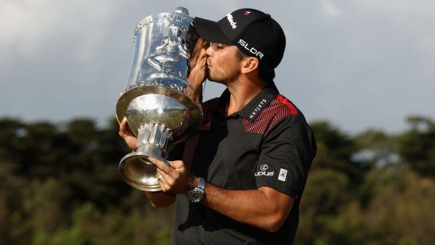 Jason Day of Australia poses with the trophy after winning the tournament during day four of the World Cup of Golf at Royal Melbourne Golf Course.