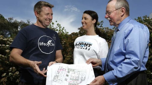 Lifecycle committee chairman Mark Blake with Leukemia Foundation fundraising manager Susan Fisher and John James Foundation CEO Phil Greenwood look over plans for John James Village that will provide residential accommodation for patients undergoing blood cancer treatment.