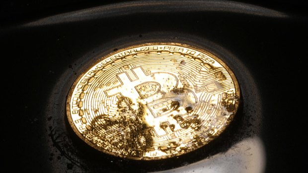 A coin representing Bitcoin, another cryptocurrency