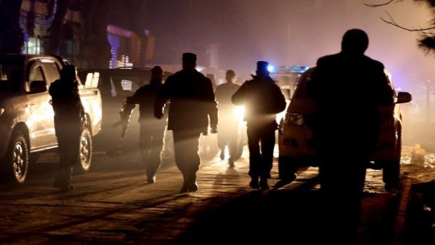 Foreigners targeted: Afghan security forces at the restaurant where the bomber struck.