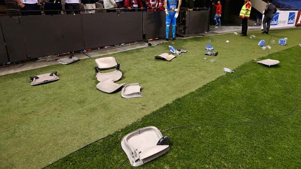 Broken seats on the pitch after Victory defeated Heart.