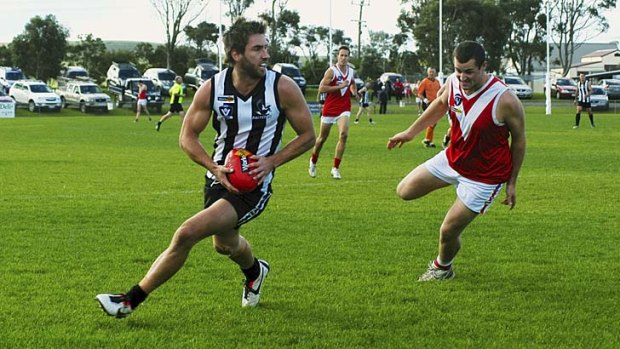 Star in stripes: Former Carlton forward Brad Fisher on the run for Dalyston.