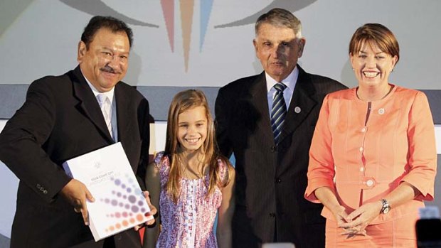 Vice President of Commonwealth Games Federation Tunku Imran (left) receives the candidate file from Queensland Premier Anna Bligh, Mayor of Gold Coast City Ron Clarke and Eve Lutze, representative of Gold Coast youths in May, 2011.
