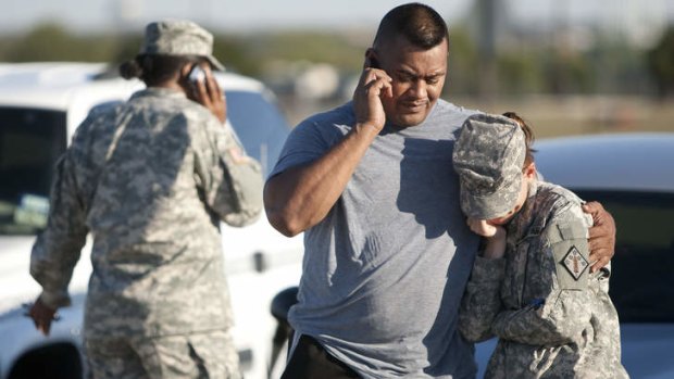 A soldier is comforted by a colleague after the Fort Hood massacre in 2009.