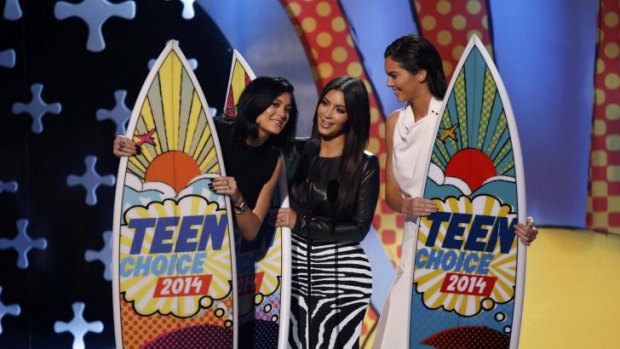 Kylie Jenner, Kim Kardashian and Kendall Jenner accept a Teen Choice Award.