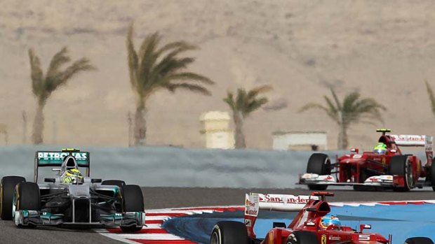 Tight tussle ... Fernando Alonso leads Nico Rosberg during the Bahrain Grand Prix.