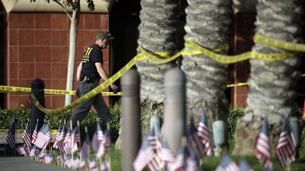 An investigator works the site of the shooting.