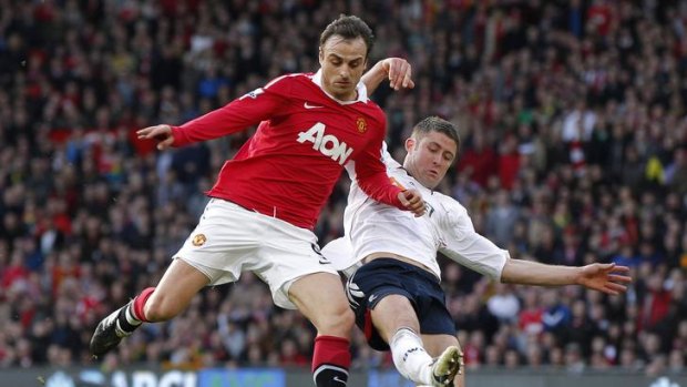 Bolton defender Gary Cahill (right, pictured challenging Manchester United's Dimitar Berbatov) has completed his transfer to Chelsea.