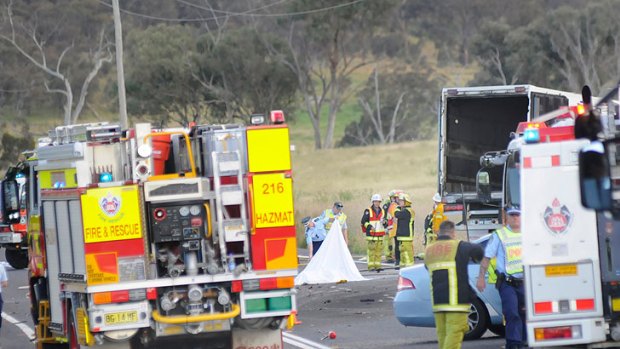 Death on the highway ... emergency crews clean up after the motorcyclist hit the front of the semitrailer near Bathurst.