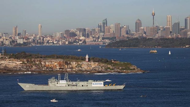 Final journey ... HMAS Adelaide was towed out of Sydney Harbour on Monday.