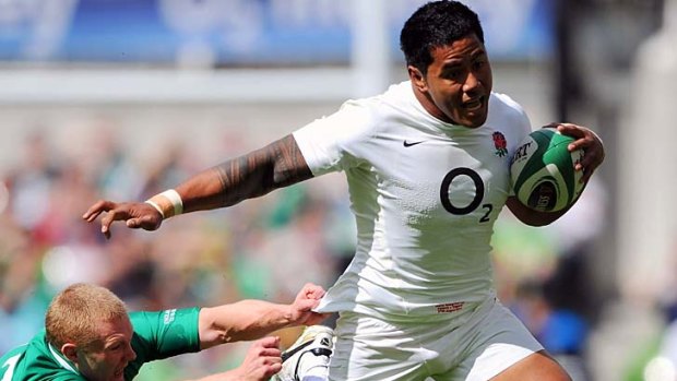 Manu Tuilagi of England breaks the tackle of Keith Earls of Ireland on his way to scoring the opening try.