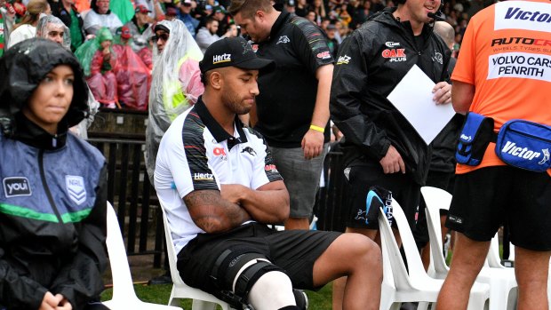 Early setback: Viliame Kikau rests his injured knee at Redfern Oval on Saturday.
