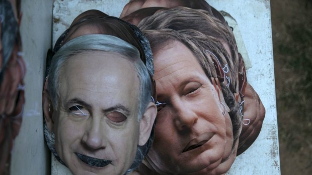 Masks depicting Israel's Prime Minister Benjamin Netanyahu, left, and Isaac Herzog, co-leader of the centre-left Zionist Union party, abandoned in a park in Tel Aviv on Monday.  