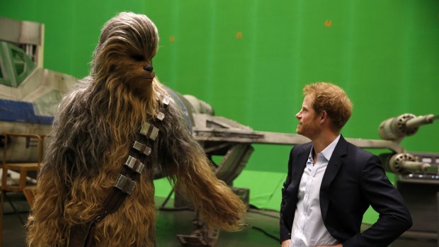 When Harry met Chewie ... Britain's Prince Harry gets some acting tips from Chewbacca during a tour of the Star Wars sets at Pinewood studios in Iver Heath, west London on April 19.