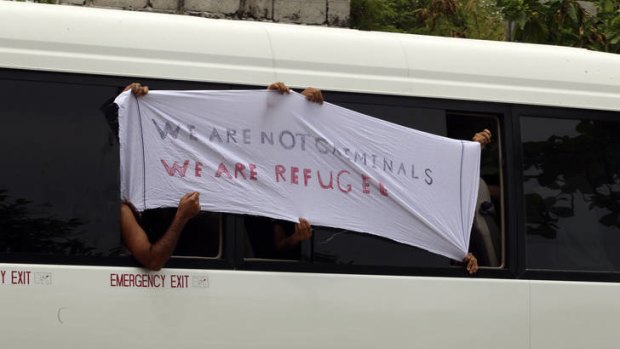 Asylum seekers protest to the media outside the Nauru courthouse.