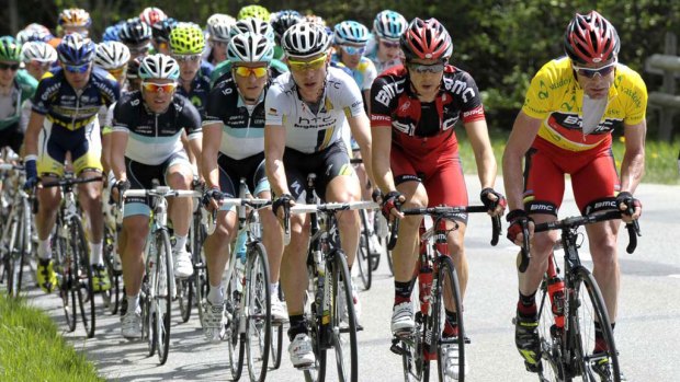 Overall victory in sight ... Cadel Evans (leader's yellow jersey) rides with the pack during the final stage of the Tour de Romandy in Switzerland.