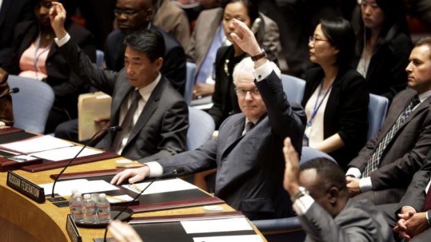 Members of the security council, including Russian Ambassador to the United Nations Vitaly Churkin, centre, vote in favour of the resolution.