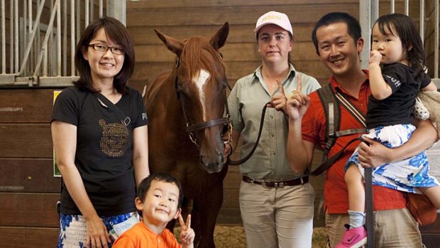 Back for more ... Tomohiro Sekiguchi, right, with his family and the $140,000 Sebring filly.