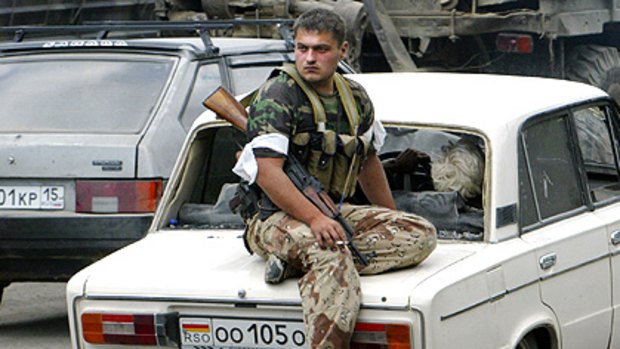 A South Ossetian separatist fighter sits on a car near the town of Dzhava, South Ossetia.