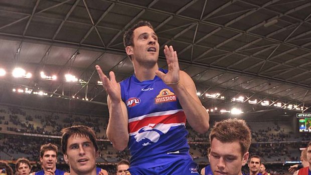 Top Dog: Western Bulldogs 200-gamer Lindsay Gilbee is carried from Etihad Stadium after his side's 27-point win over Carlton.