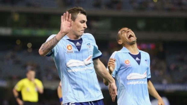 Sebastian Ryall of Sydney FC celebrates after levelling the score at 1-1 as Ali Abbas laughs.