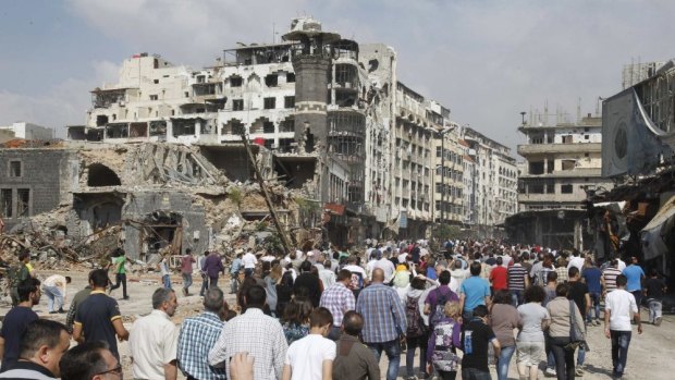 Ghost town: Homs residents arrive to inspect their homes.