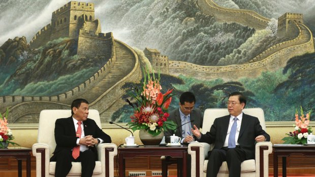 Philippine President Rodrigo Duterte, left, listens to Zhang Dejiang, chairman of the Standing Committee of the National People's Congress of China.