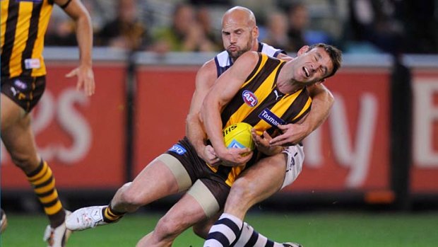 Hawthorn's Brent Guerra tackled by Geelong's Paul Chapman.