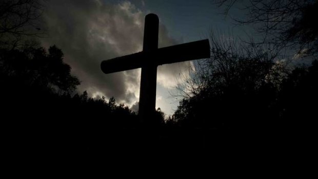 A metal cross at the cemetery.