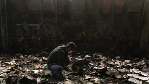 Sifting through debris: A man in a burnt-out bank in Mariupol.
