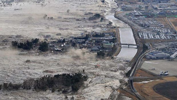 Tsunami: waves wash over land in Iwanuma, northern Japan.