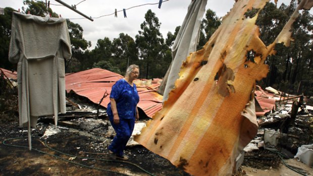 Devastating: Lori Mansfield wanders through the remains of what was once her Boolarra home.