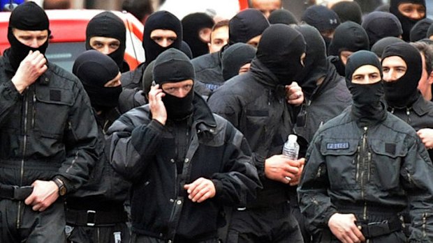 Members of the RAID special police unit leave after the assault on the Toulouse flat of self-professed al-Qaeda militant Mohammed Merah.