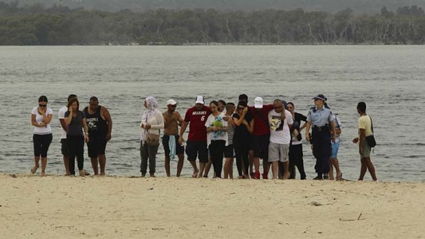 Ayman Ksebe's family gather at the water's edge at Doll's Point a day after the five-year-old drowned when he slipped into a trench.