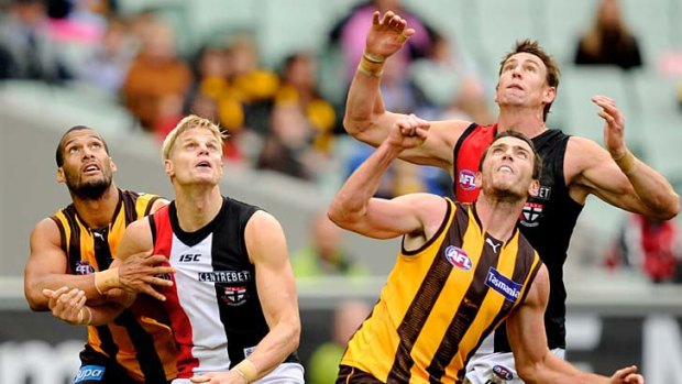 Eyes on the ball: Hawks Josh Gibson (left) and Thomas Murphy, with Saints Nick Riewoldt and Justin Koschitzke set themselves for a mark yesterday.