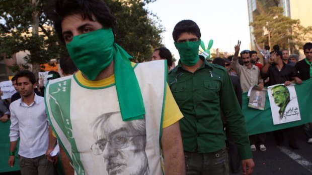 Twitpic ... allegedly shows Iranian supporters of defeated candidate Mir Hossein Mousavi covering their mouths with green scarfs, Mousavi's campaign colour, during a 2009 rally in Tehran.