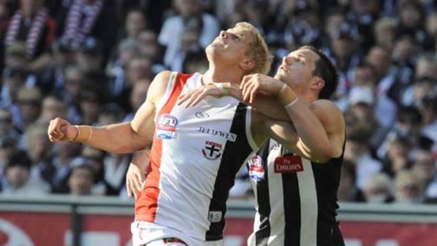 Nathan Brown tries to come with grips with  Nick Riewoldt.