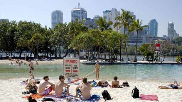 Swimmers and sunbakers enjoy the hot weather at South Bank Brisbane.