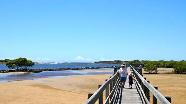 Coasting ... Urunga boardwalk stretches from the river to the beach and the mangroves.