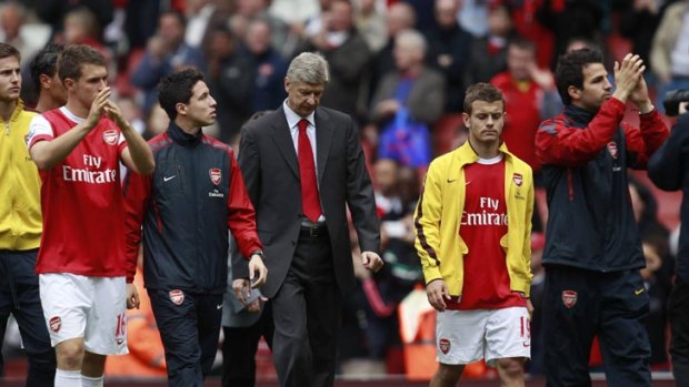 Arsene Wenger (centre) and his players do a lap of honour to thank their supporters after their English Premier League loss to Aston Villa at Emirates Stadium.