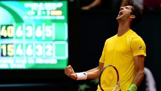 Thomaz Bellucci of Brazil reacts after winning his play-off singles match against Roberto Bautista Agut of Spain.