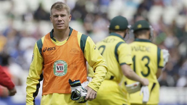 Sidelined ... David Warner walks off the field after a drinks break in his role a non-playing reserve on Wednesday.