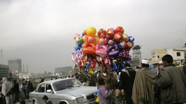 From rags to riches... a man sells inflatable toys in Kabul, Afghanistan, where the Government hopes to triple revenue within five years.