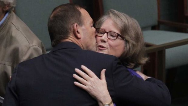 Opposition Leader Tony Abbott embraces Liberal MP Judi Moylan after her valedictory speech on Monday.